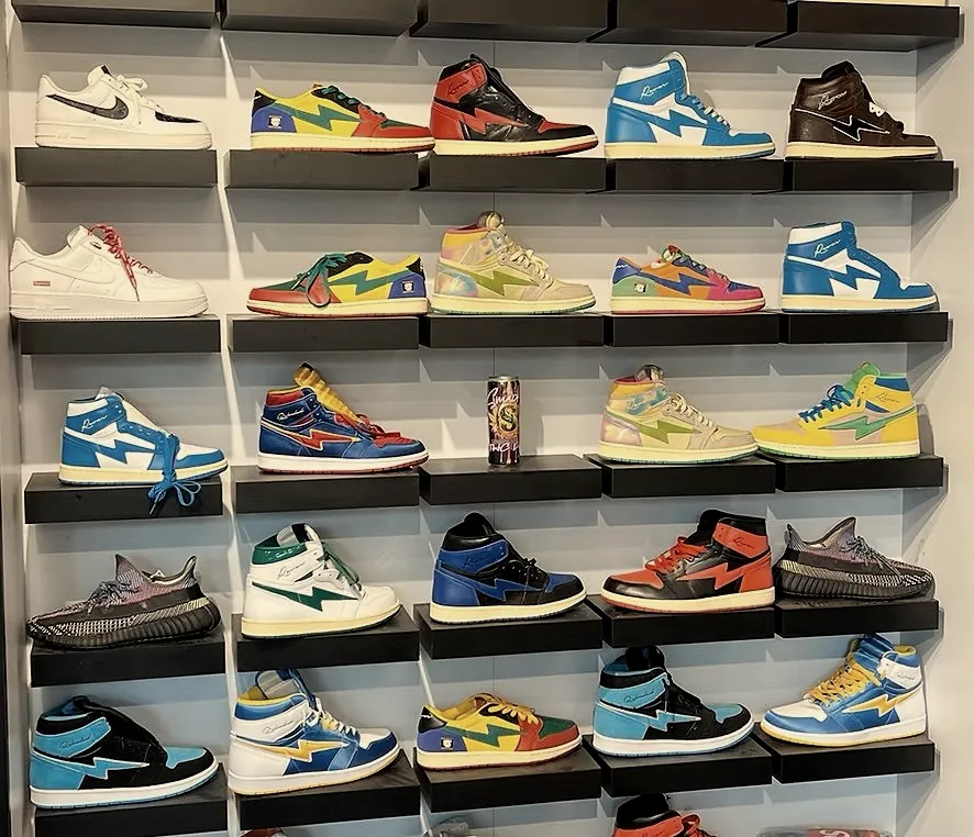 A wall of sneakers on black floating shelves